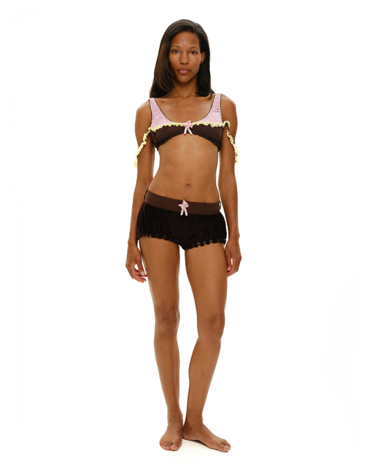 Black rosette-ruffle shorts with scalloped hem and light pink bow at front