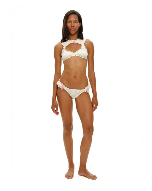White tanga underwear with rosette accents and scalloped lace trim