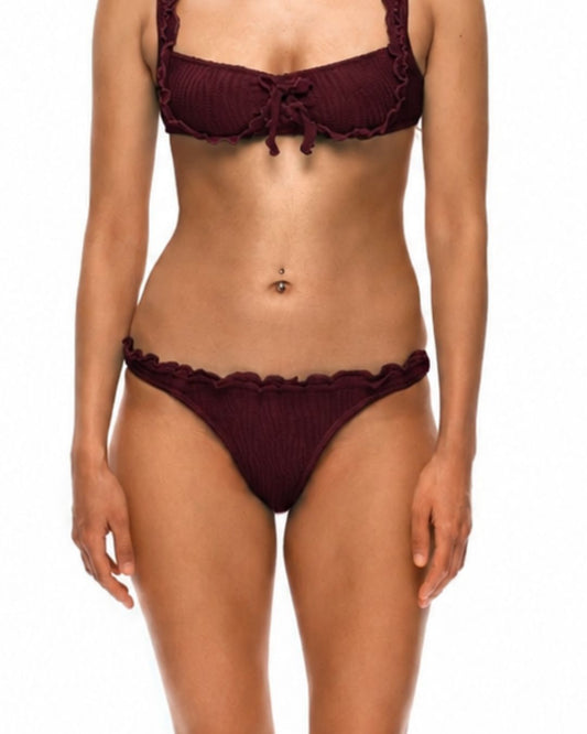 Burgundy bikini bottoms with ruffled hem and scalloped trim, on model