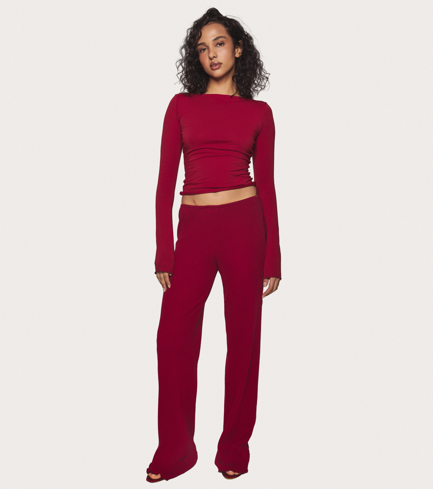 Burgundy pajama pants with wide leg fit and full-length silhouette.