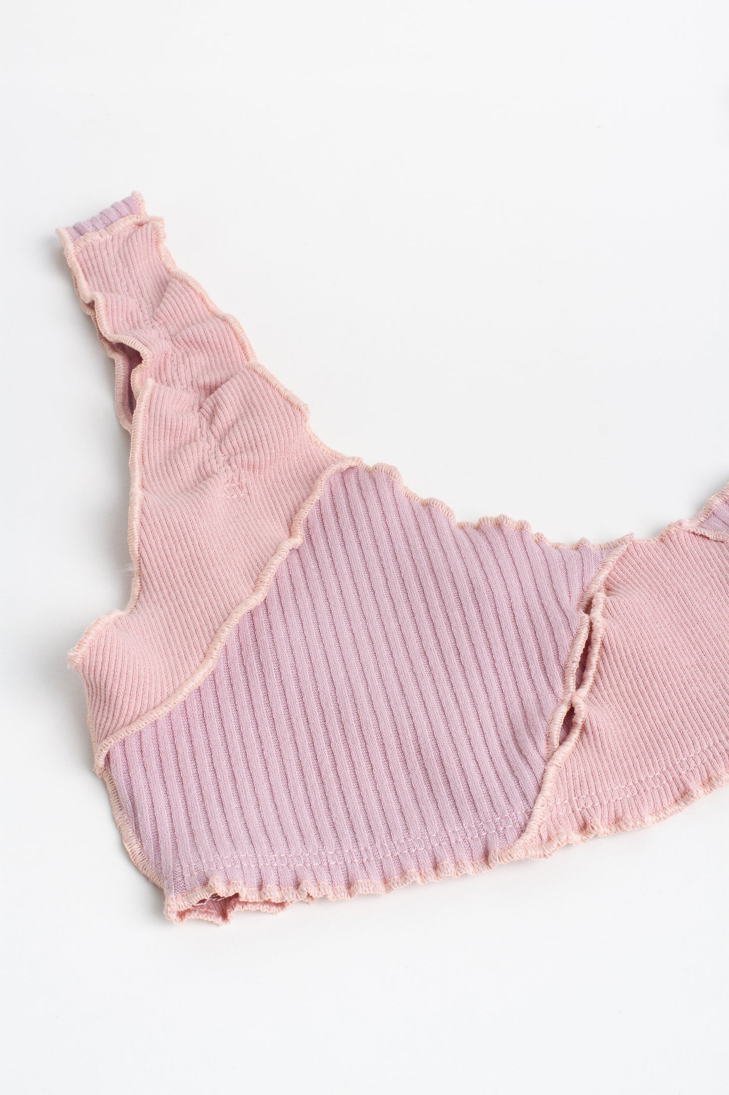 Pink ribbed bralette with ruffled trim and scalloped-edged armholes