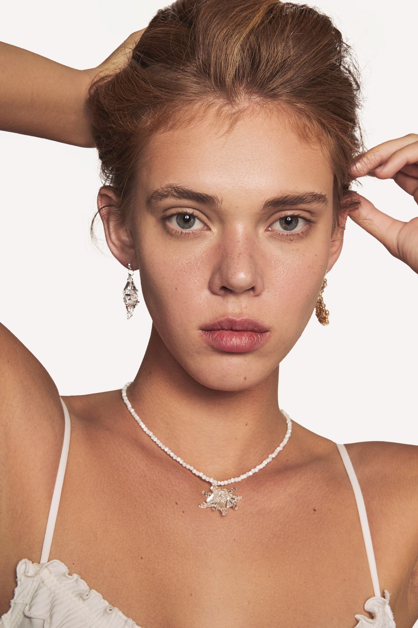 Crystal star pendant pearl-bead necklace worn at the collarbone
