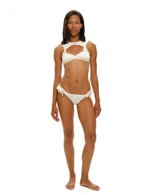 White ruffle-trim bra top with scalloped cups and pink rosette accents
