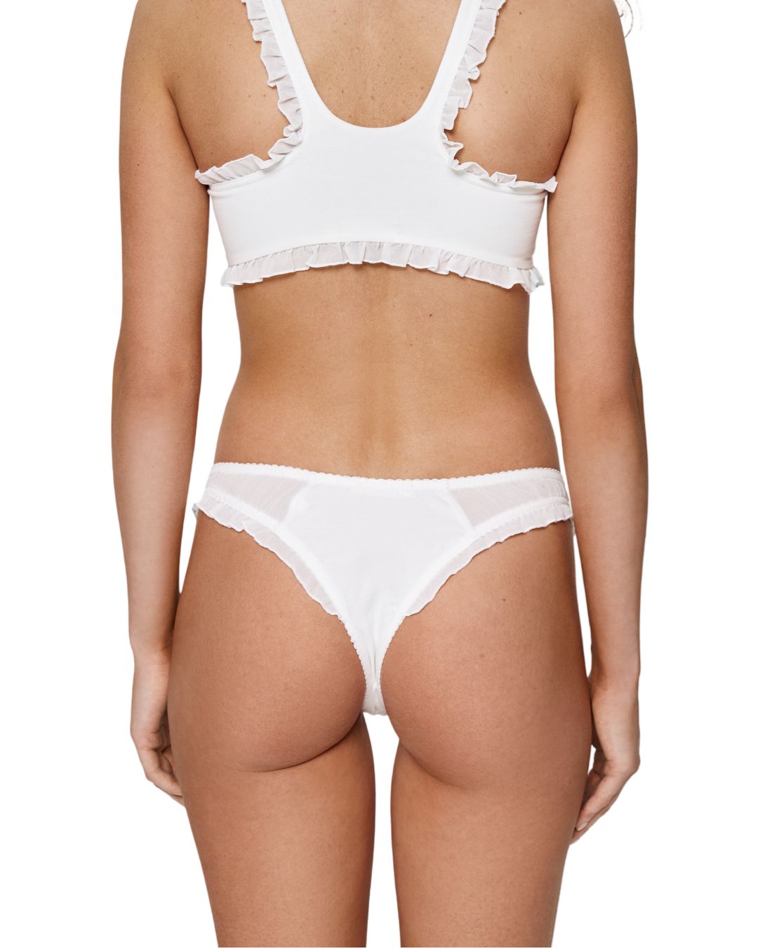 White ruffle-trim tanga with heart patch at center, worn under bra top