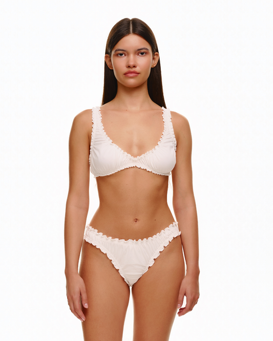 White ruched bikini top with ruffled trim and matching bottoms, front view