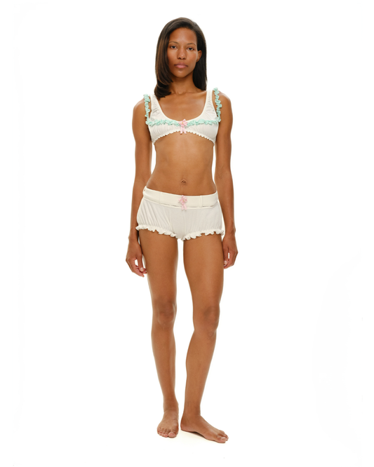 Ruffle-trim bra and matching white shorts with light mint edging and pink bow