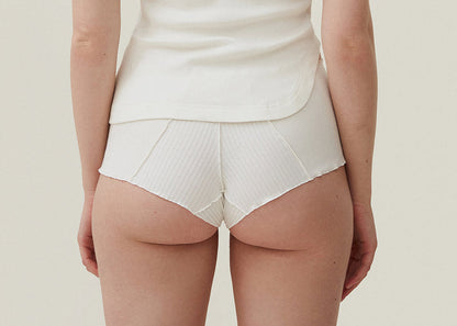 White ribbed boyshorts with V-shaped center seam and scalloped edges