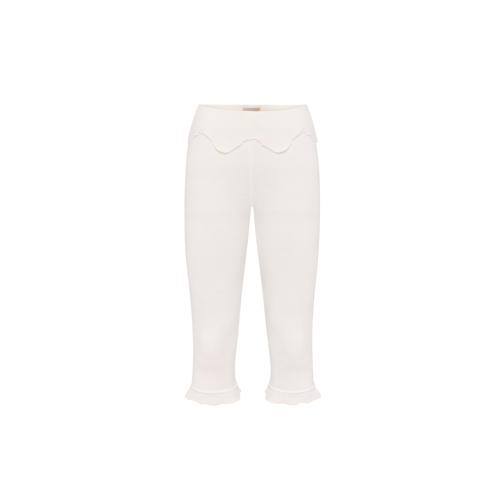 White wavy capri pants with scalloped waist detail and cropped flared cuffs.