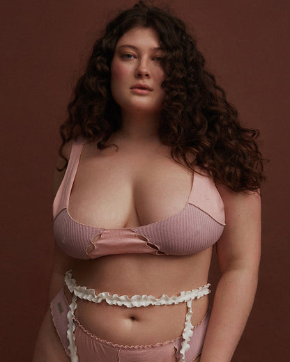 Pink ribbed bralette with ruffled edges and curved scoop neckline