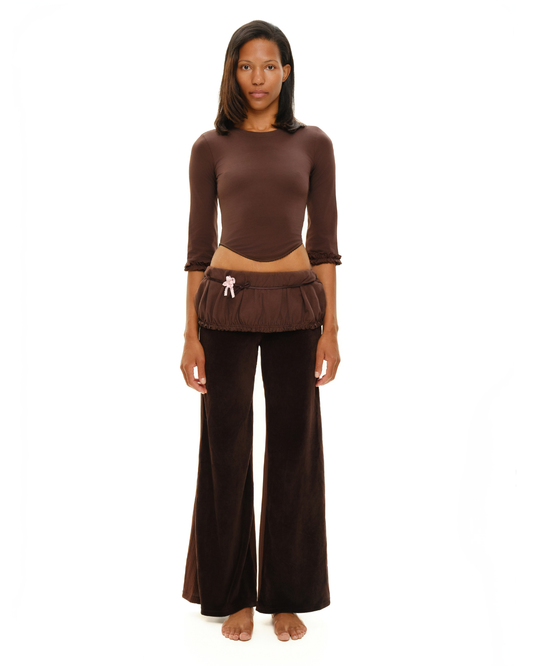 Brown long-sleeve top with gathered cuffs; ruched hem and small tassel detail
