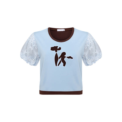 Light blue cropped T-shirt with brown neckline trim and white lace puff sleeves; brown dancer graphic