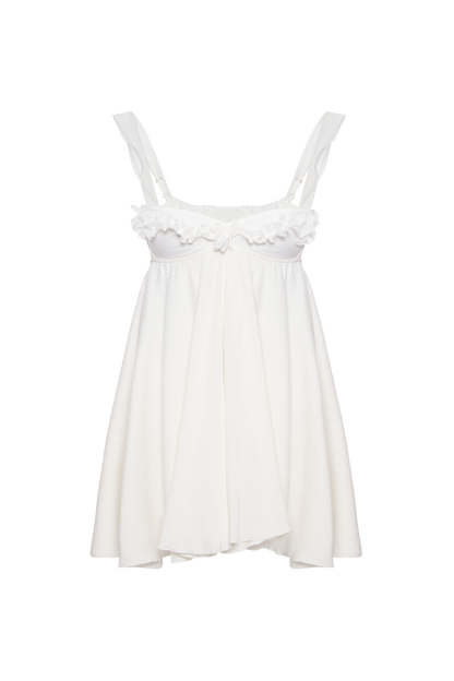 White ruffled dress with thin straps and gathered skirt