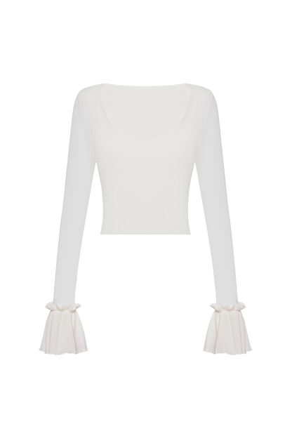 White ribbed long-sleeve top with ruffled cuffs and scoop neckline