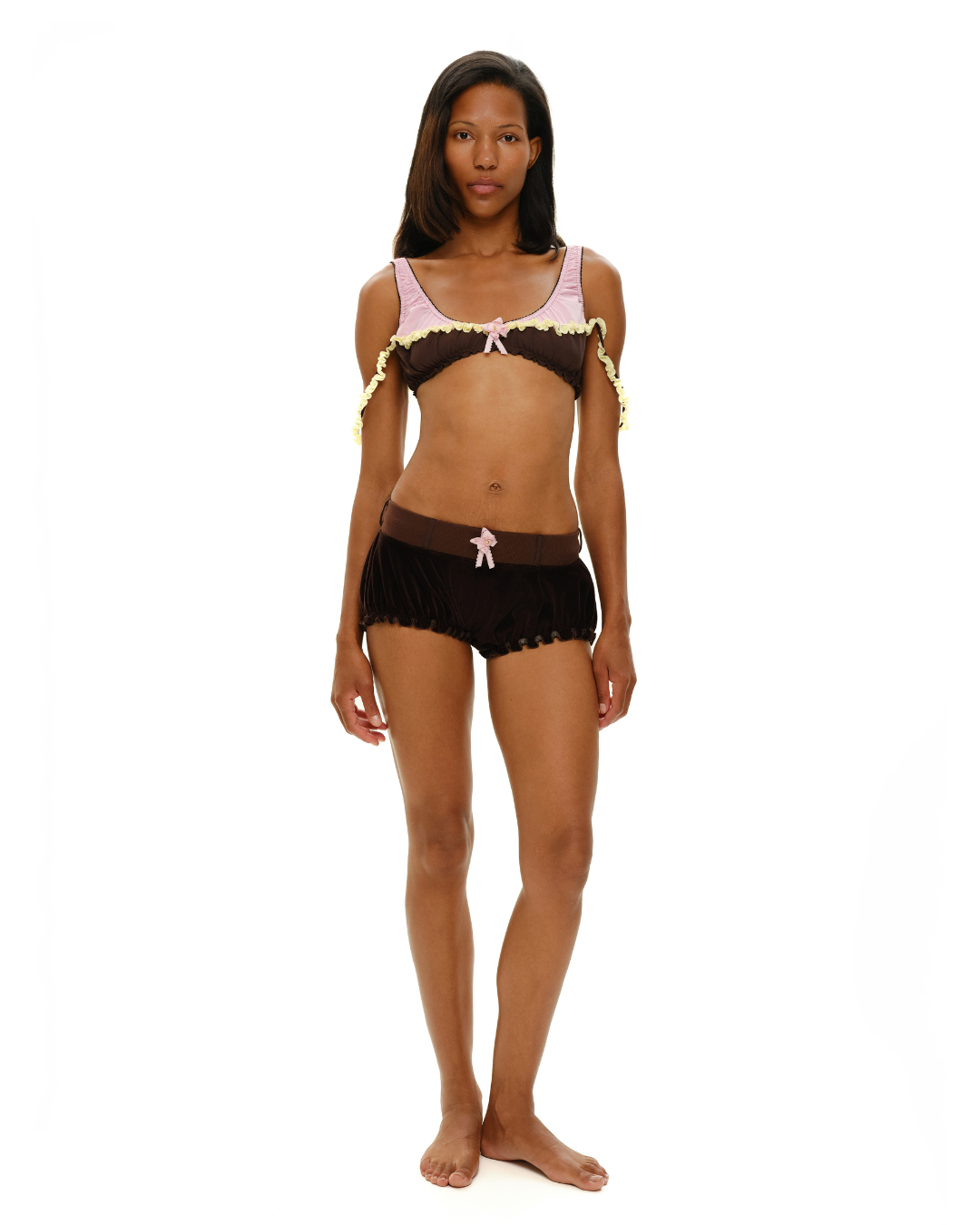 Black rosette-ruffle shorts with scalloped hem and light pink bow at front
