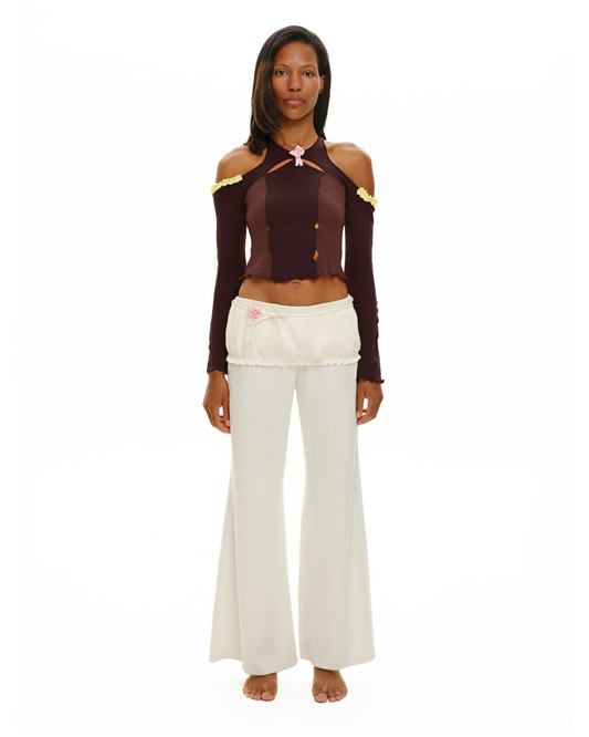 Brown long-sleeve off-shoulder top with pink rosette at neckline