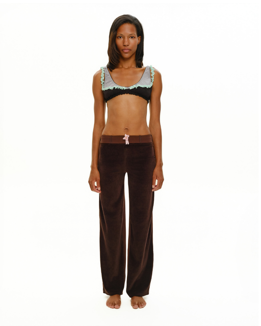 Black bra top with mint ruffled shoulder straps and scalloped neckline