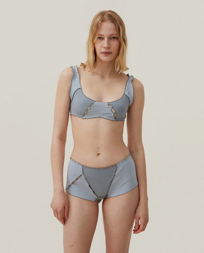 Light blue ribbed bralette with scalloped neckline, thin straps, tie trim