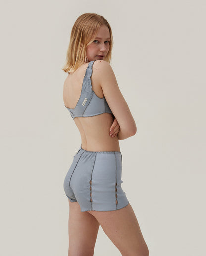 Light blue ribbed bralette shown from the side with tie-trim detailing