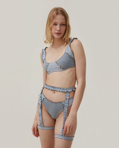 Blue ribbed tanga with ruffle trim and decorative side ties