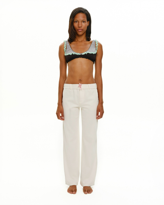White wide-leg trousers with pink ribbon drawstring, front view