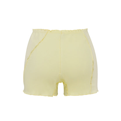 Light yellow shorts with elastic waistband and center seam, raw hem