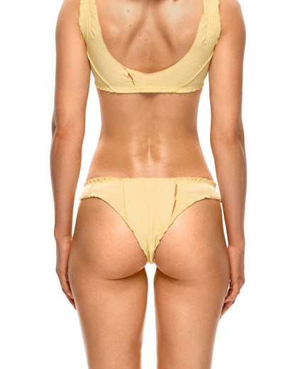 Yellow tanga underwear on model from behind, minimal coverage