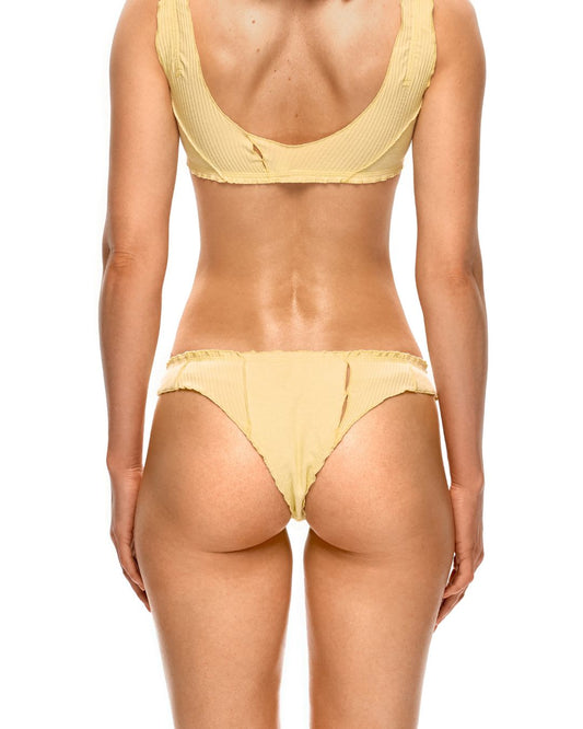 Yellow tanga underwear on model from behind, minimal coverage