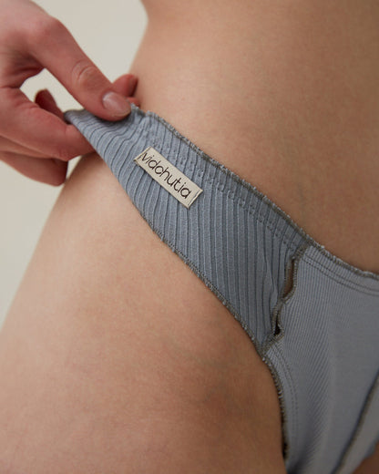 Blue ribbed thong waistband with logo label and stitched leg edge
