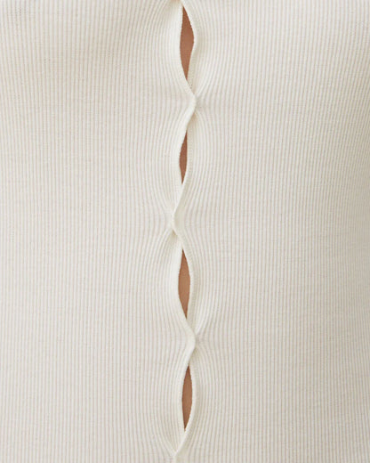 White ribbed draped T-shirt close-up with center-front slit detail