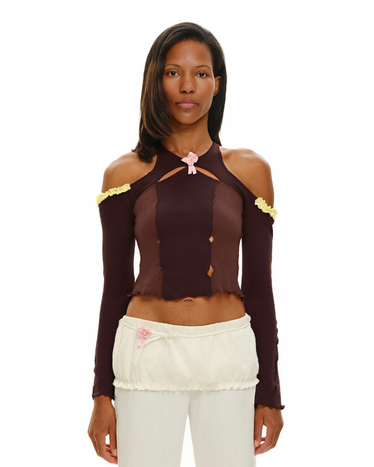 Brown long-sleeve top with pink rosette at halter neckline and open shoulders