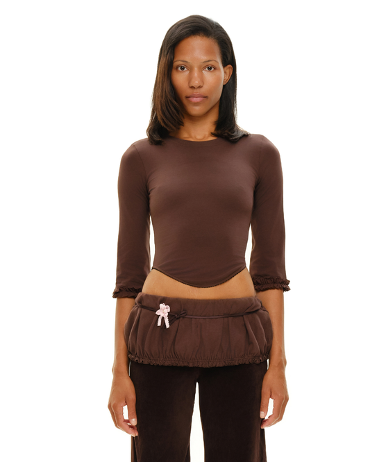 Brown long-sleeve fitted top with gathered cuffs and ruched front hem detail