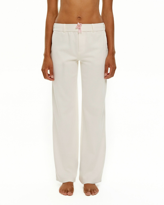 White wide-leg trousers with pink ribbon bow at waist