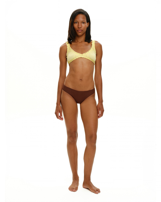 Brown seamless tanga worn by model, high-cut leg openings and wide waistband.
