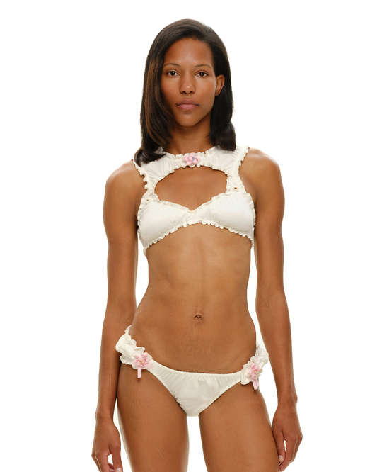 White rosette bra top with ruffled neckline and pink floral detail
