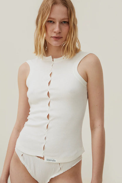 White sleeveless draped T-shirt with center-front slit placket and narrow straps