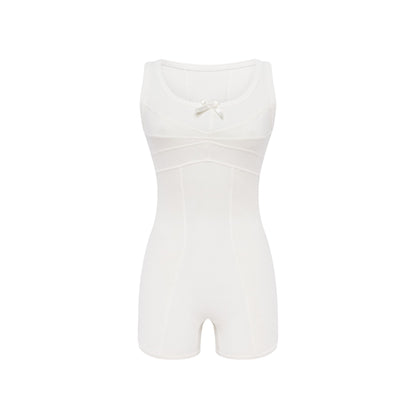 White sleeveless jumpsuit with bow detail at scoop neckline, fitted shorts