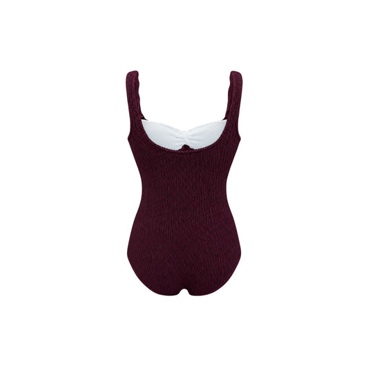 One-piece swimsuit, dark maroon textured knit, scoop neckline and high leg.