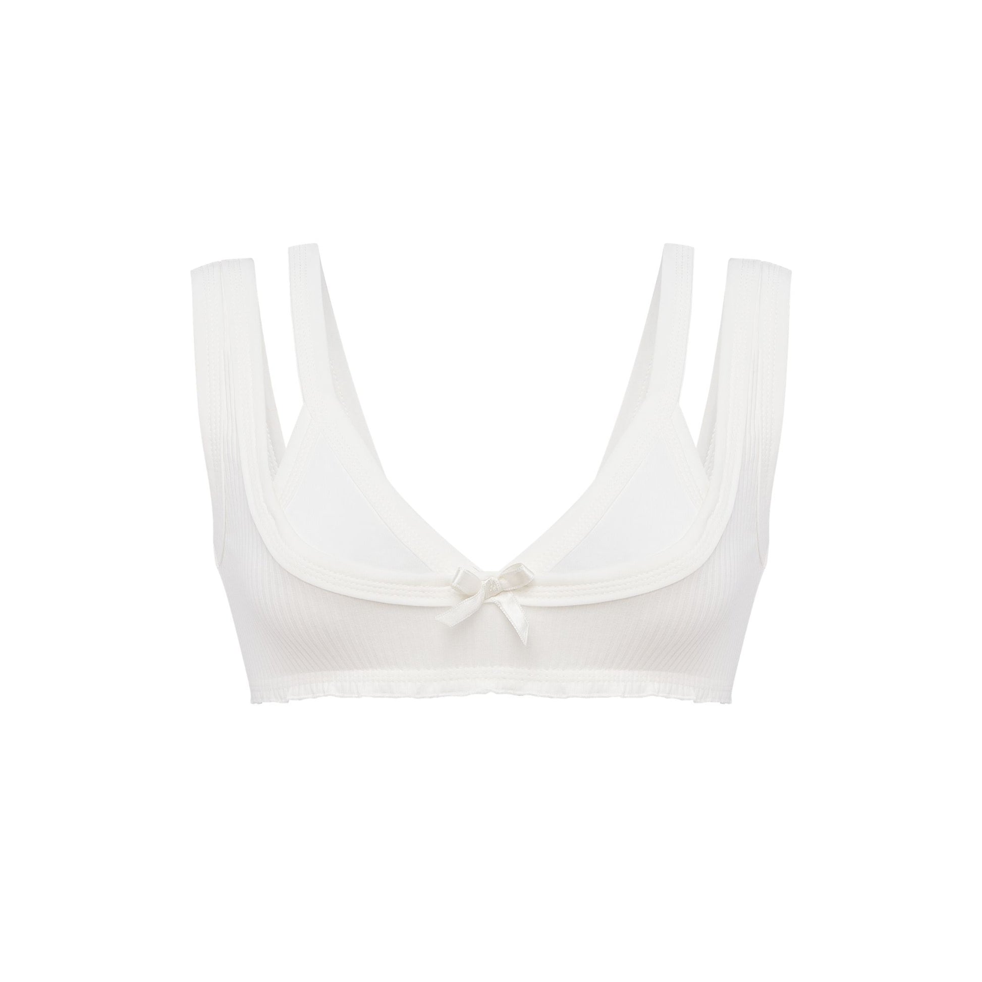 White bralette top with scalloped scoop neckline, thin straps, and center bow detail