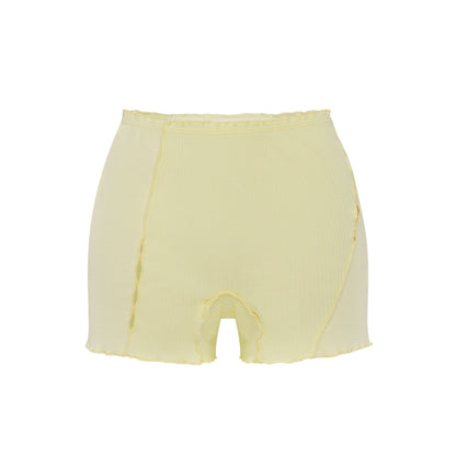 Light yellow shorts with elastic waistband and curved raw edges
