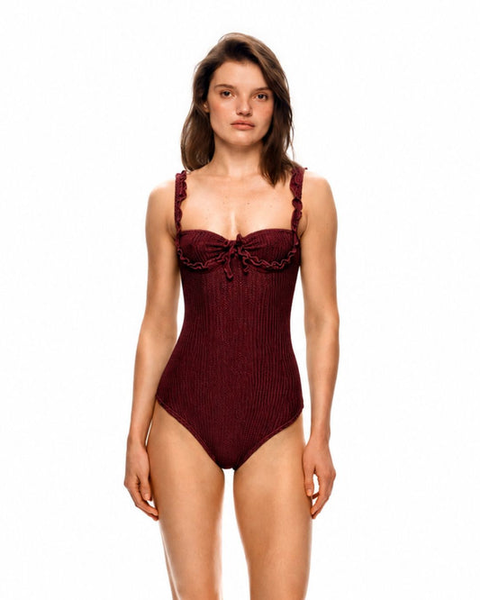One-piece swimsuit in dark burgundy with wave trim and tie at bust, slim leg cut