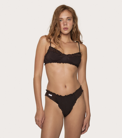 Brown lace-trim tanga underwear with thin straps, worn on a model