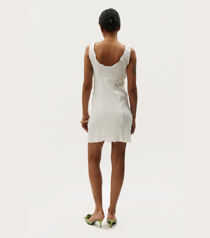 White sleeveless wavy mini dress, low back scooped neckline