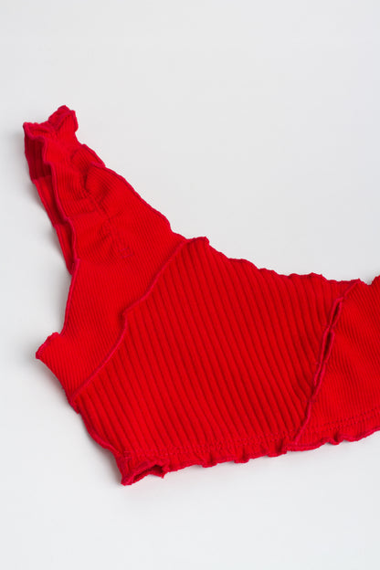 Red ribbed cropped bralette top laid flat with scoop neckline and stitched cutouts