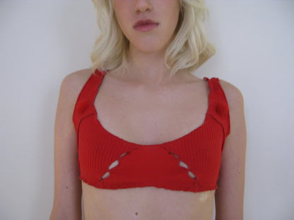 Red ribbed bralette top close-up with scoop neckline and stitched cutout panel