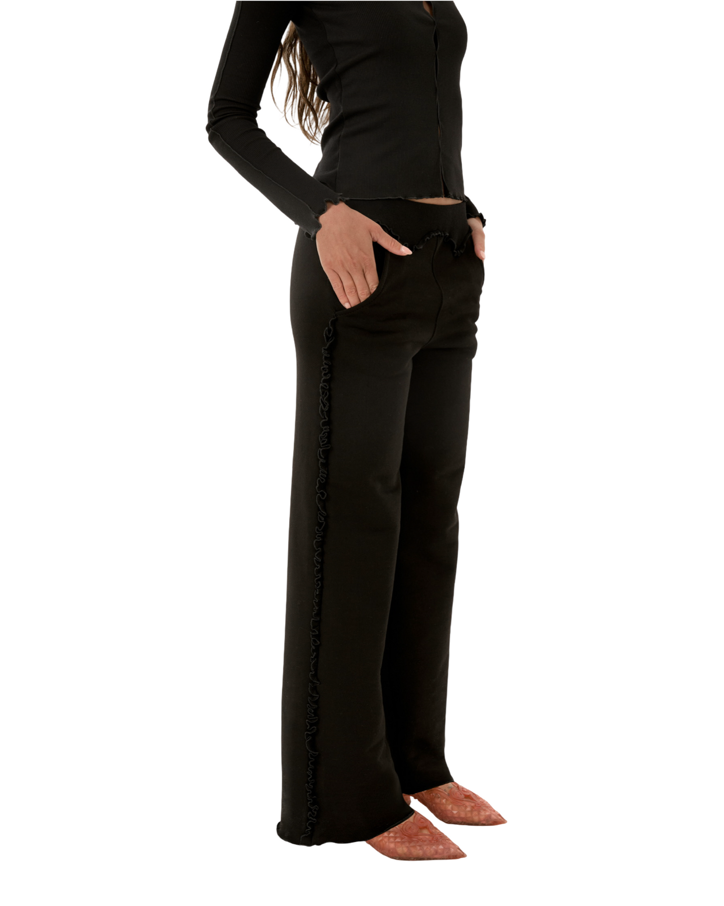 Black flared pants with ruffled wavy trim along side seam.