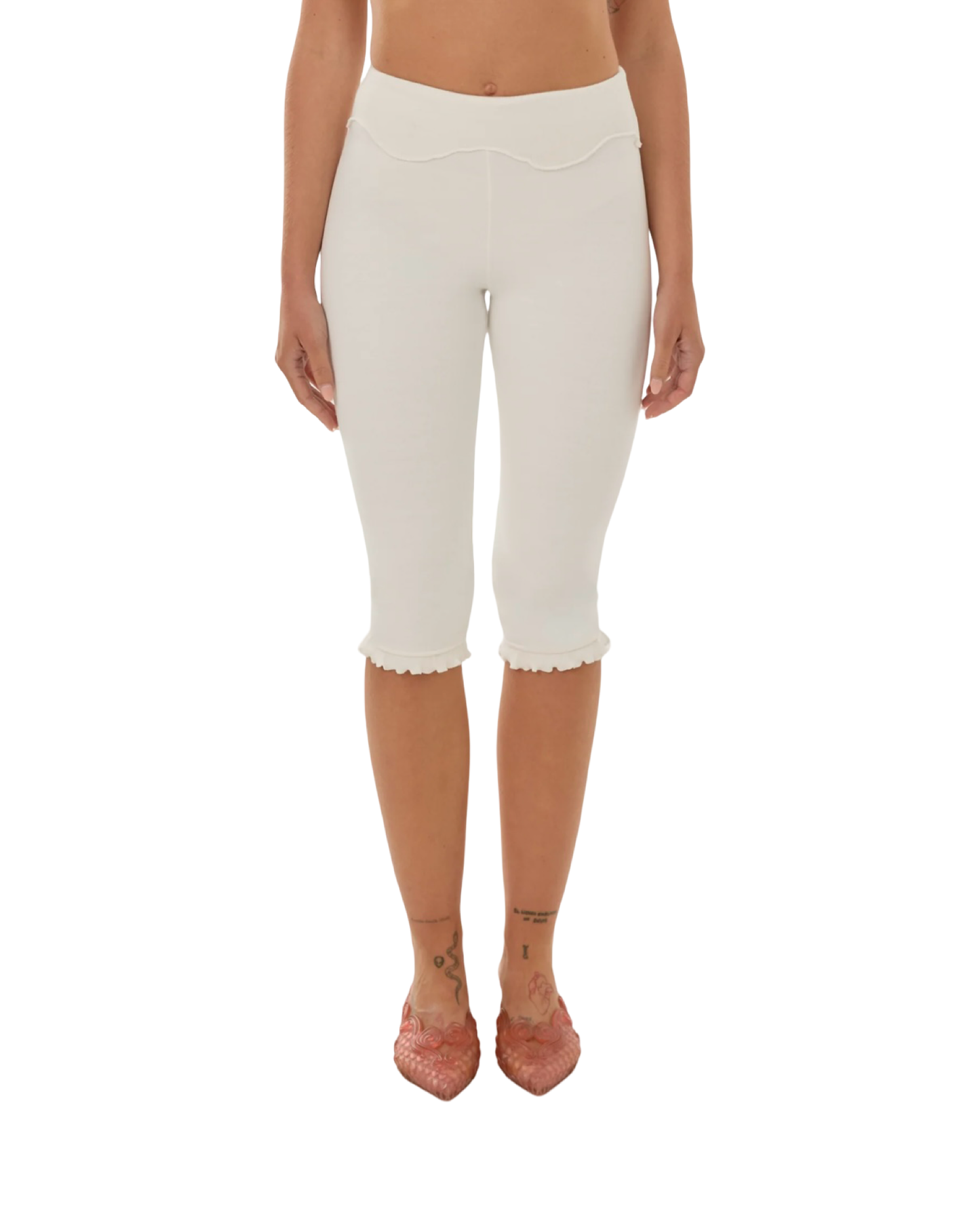White high-rise capri pants with wavy yoke and scalloped hem.