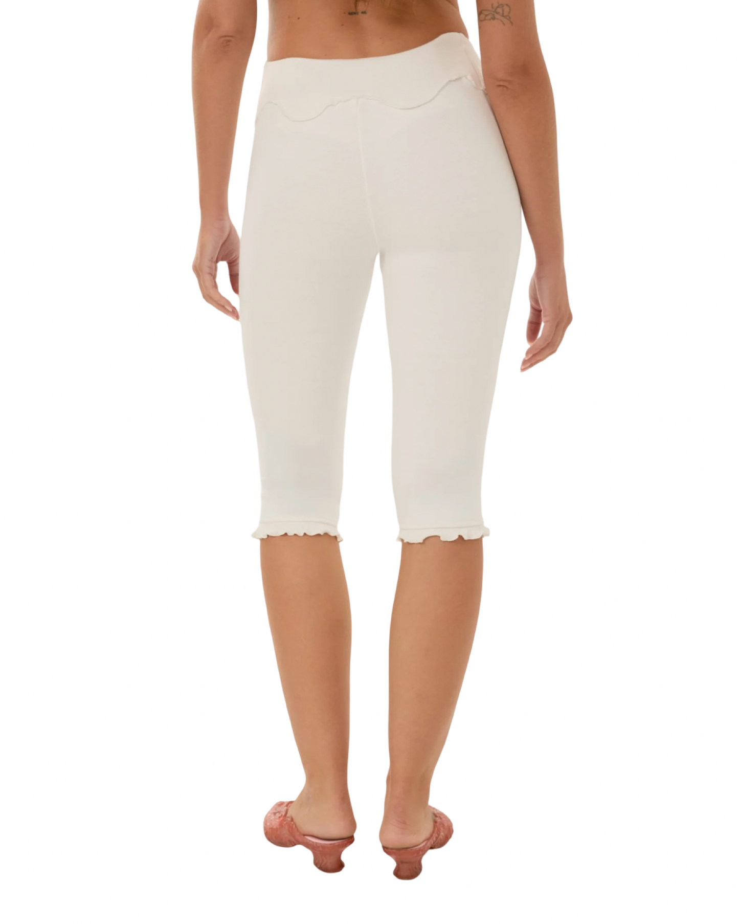 White capri pants with wavy yoke front and scalloped hem detail.
