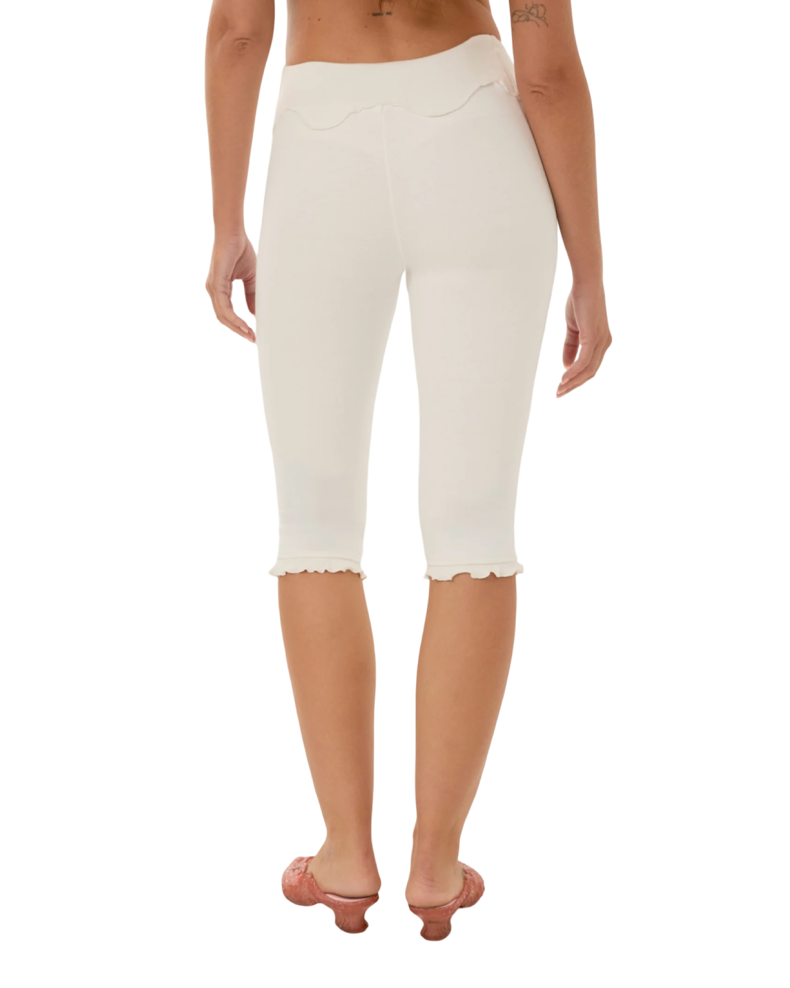 White capri pants with wavy yoke front and scalloped hem detail.