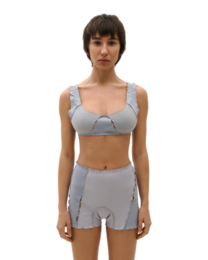 Light blue ribbed knit shorts with elastic waistband, scalloped hem, decorative loop stitching.