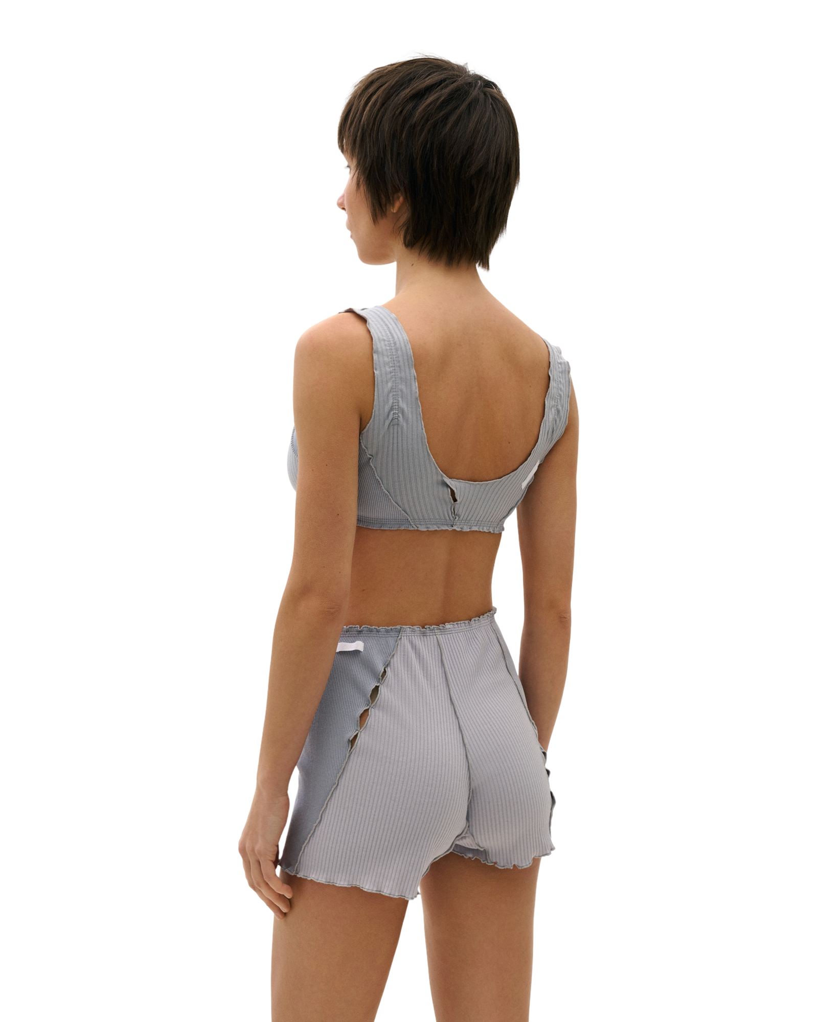 Light blue ribbed knit shorts, rear view, elastic waistband and scalloped hem, decorative trim.
